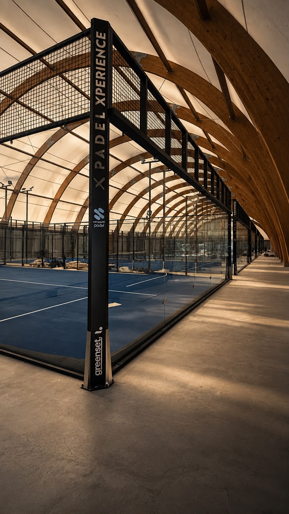 Piste de padel Padel Xperience en cours de montage dans le Woodpad, structure noire et verrières